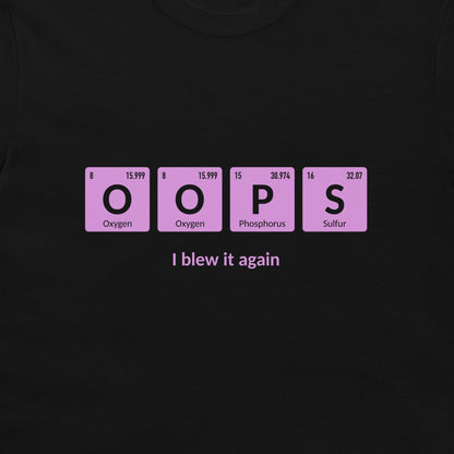 A black t-shirt featuring a graphic of four pink periodic table style tiles spelling 'OOPS' with 'I blew it again' printed in white text underneath.