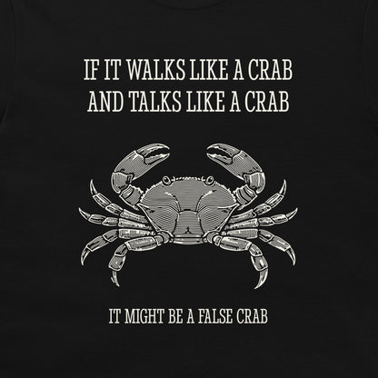 A black graphic t-shirt featuring a white line art illustration of a crab and the humorous text 'IF IT WALKS LIKE A CRAB AND TALKS LIKE A CRAB IT MIGHT BE A FALSE CRAB'.