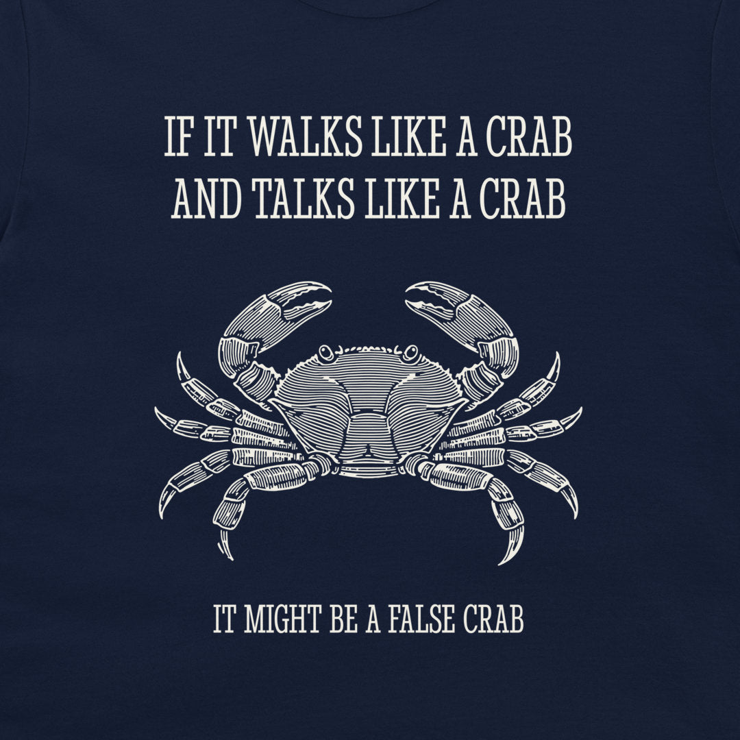 A navy blue graphic print featuring a white line art illustration of a crab and the humorous text 'IF IT WALKS LIKE A CRAB AND TALKS LIKE A CRAB IT MIGHT BE A FALSE CRAB'.