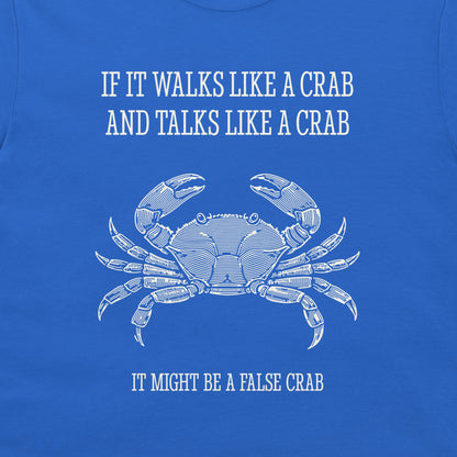 A close-up of a blue graphic t-shirt featuring a white line art illustration of a crab and the humorous text 'IF IT WALKS LIKE A CRAB AND TALKS LIKE A CRAB IT MIGHT BE A FALSE CRAB'.