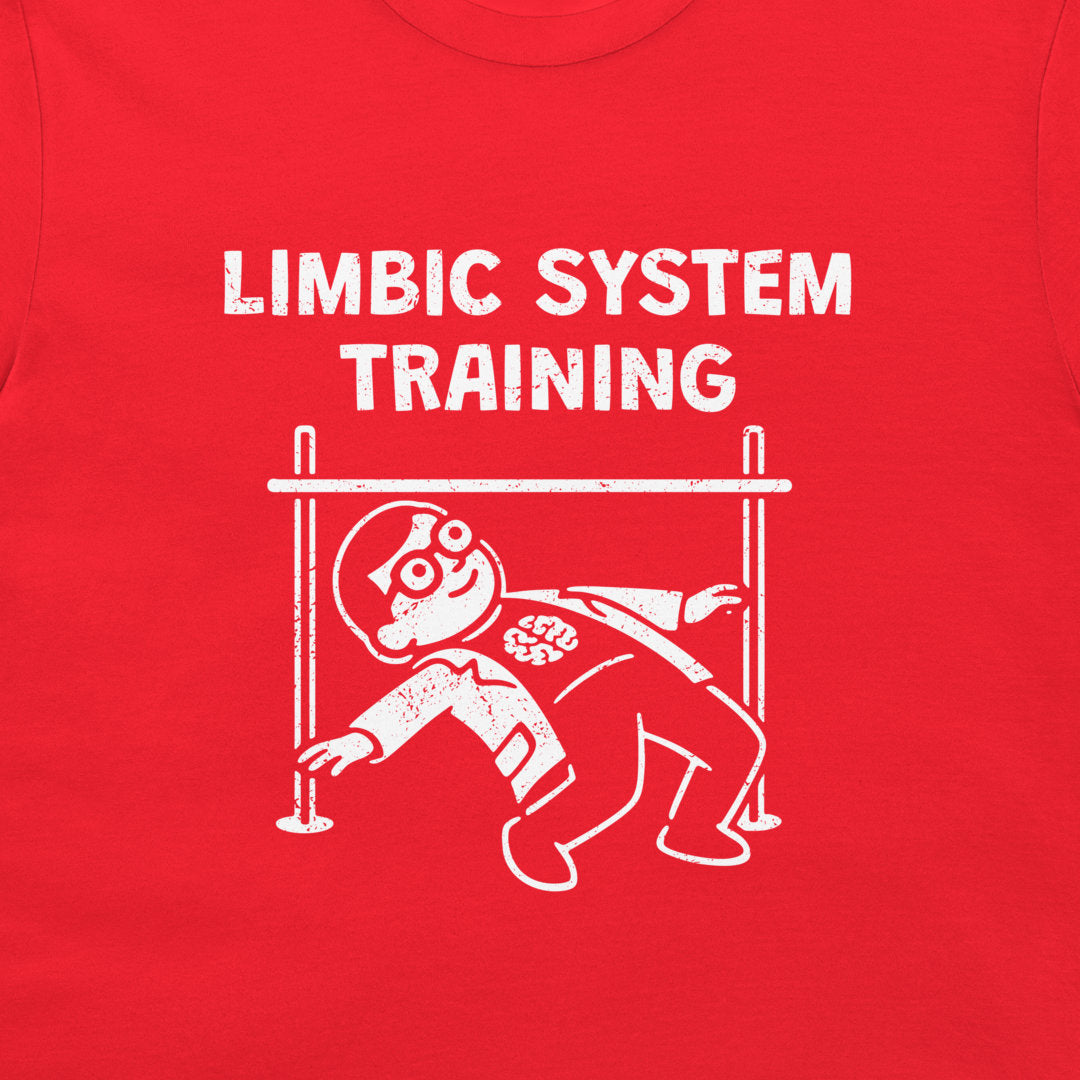 A close-up of a bright red t-shirt, featuring a distressed white graphic print that reads 'LIMBIC SYSTEM TRAINING' above a cartoon figure under a hurdle.