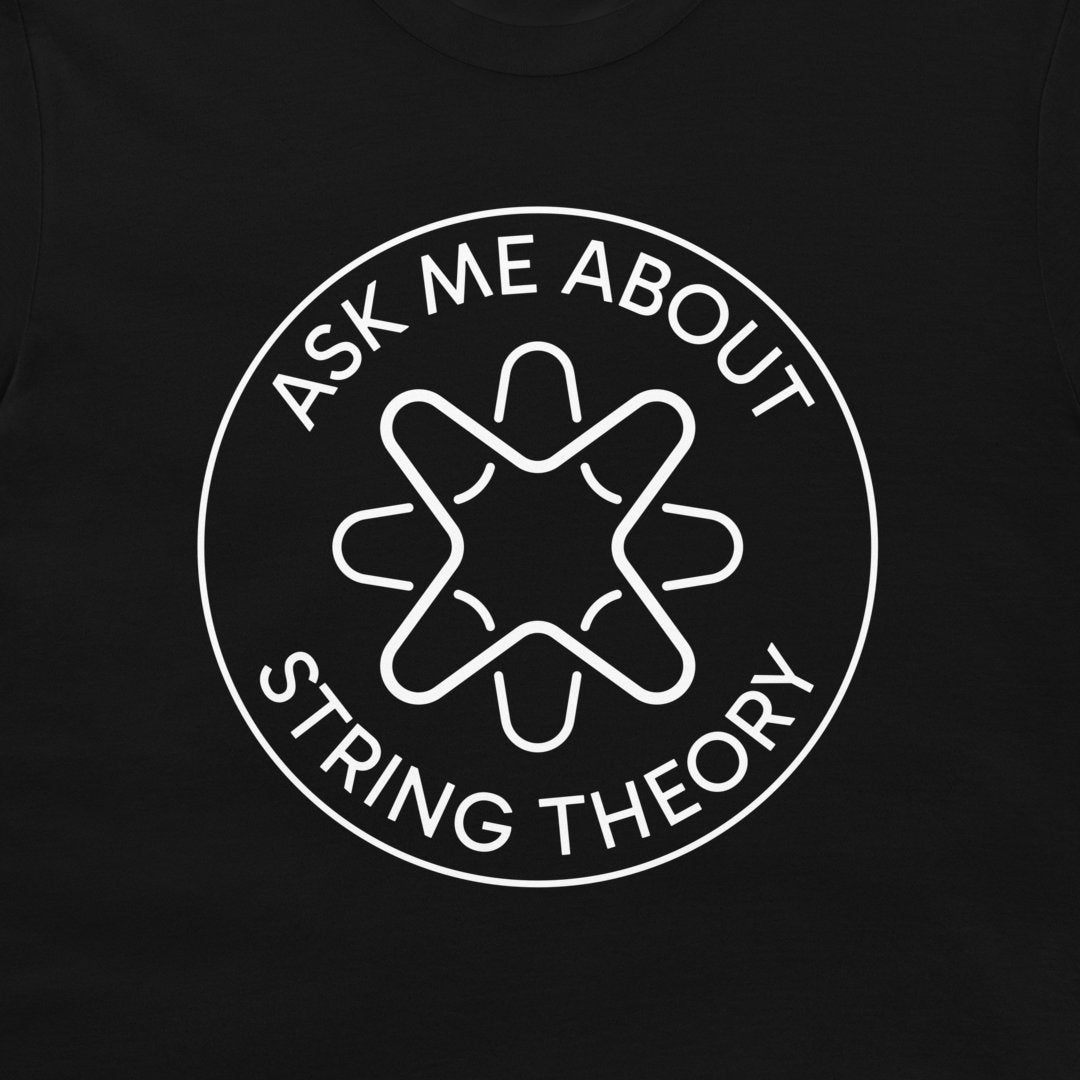 A close-up of a black t-shirt, featuring a white circular graphic with the text 'ASK ME ABOUT STRING THEORY' surrounding a stylized geometric emblem.