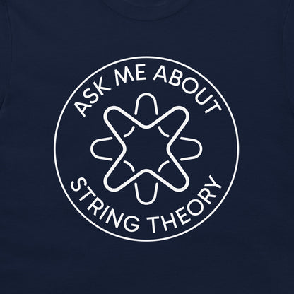 A close-up of a navy blue t-shirt, featuring a white circular graphic with the text 'ASK ME ABOUT STRING THEORY' surrounding a stylized geometric emblem.