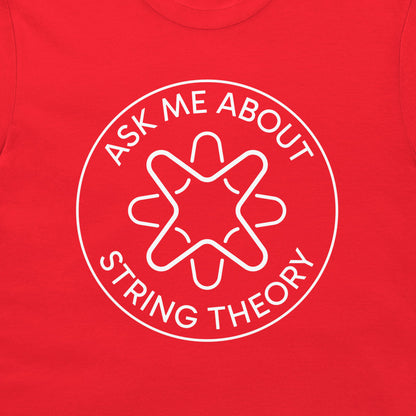 A close-up of a bright red t-shirt featuring a white circular graphic with the text 'ASK ME ABOUT STRING THEORY' surrounding a stylized graphic.