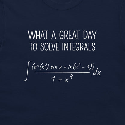 A close-up of a navy blue t-shirt featuring a white printed graphic that reads 'WHAT A GREAT DAY TO SOLVE INTEGRALS' above a complex mathematical equation.