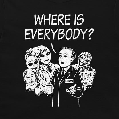 A black graphic t-shirt featuring a white hand-drawn illustration of Enrico Fermi surrounded by aliens, with the text 'WHERE IS EVERYBODY?' above them.