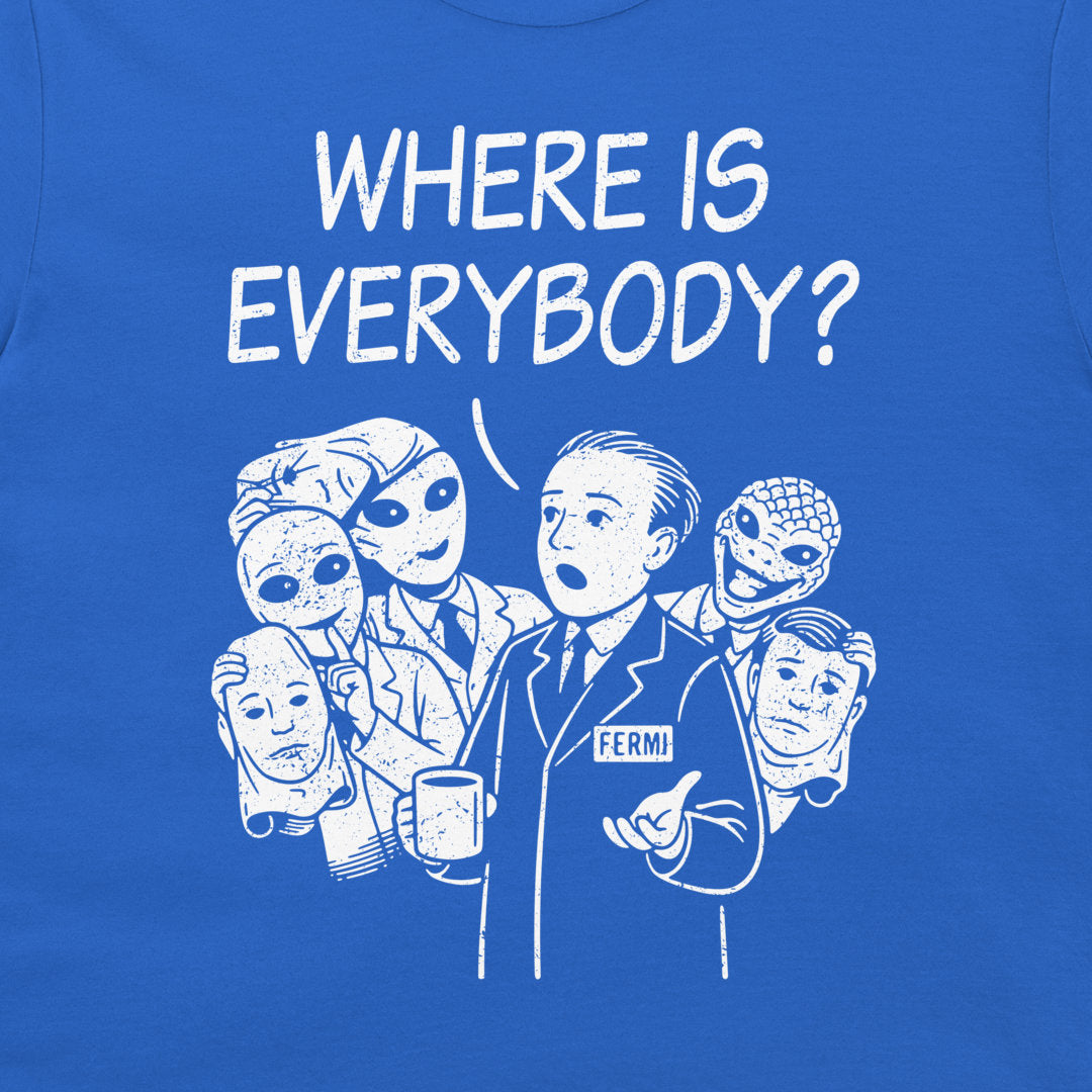 A close-up of a royal blue t-shirt featuring a white graphic print. The graphic displays the text 'WHERE IS EVERYBODY?' above an illustration of Enrico Fermi surrounded by various alien faces.