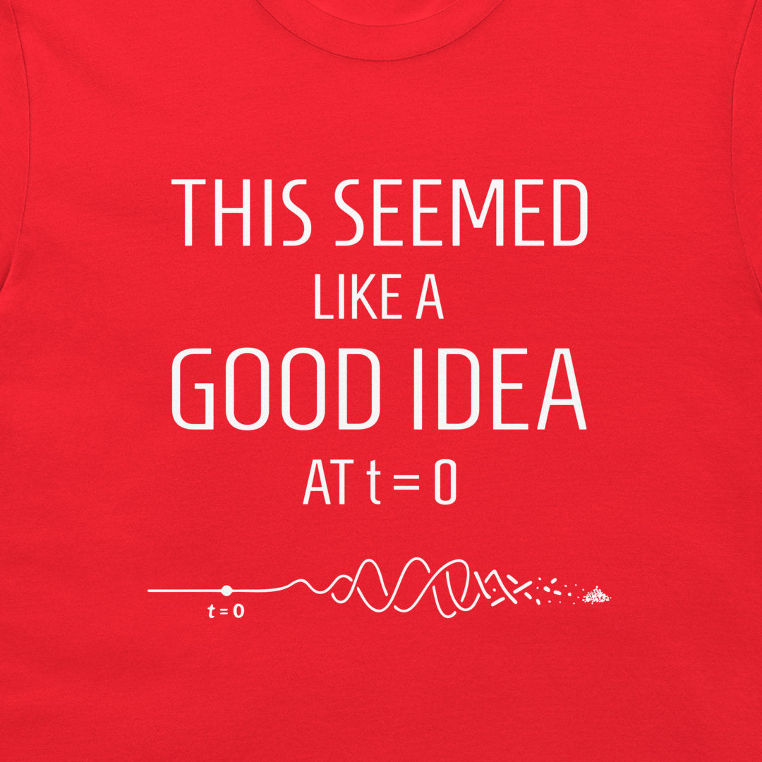 A close-up of a bright red t-shirt featuring a white graphic print that reads 'THIS SEEMED LIKE A GOOD IDEA AT t=0' above a white signal wave diagram starting at t=0.