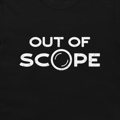 A close-up of a black t-shirt featuring a distressed white graphic print that reads 'OUT OF SCOPE' with the letter 'O' stylized as a telescope lens.