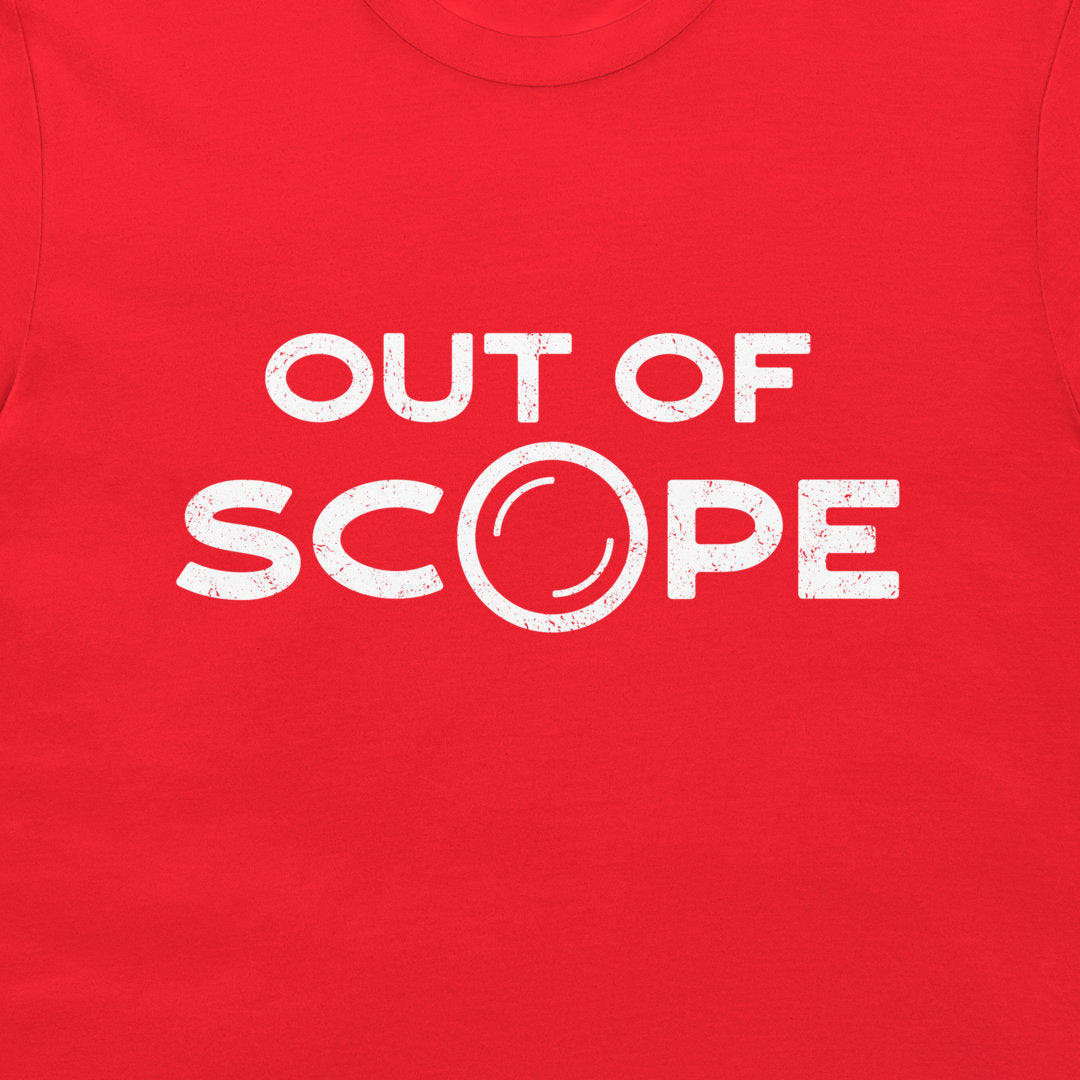 A close-up of a bright red t-shirt, featuring a distressed white graphic print that reads 'OUT OF SCOPE' with the letter 'O' stylized as a camera lens.