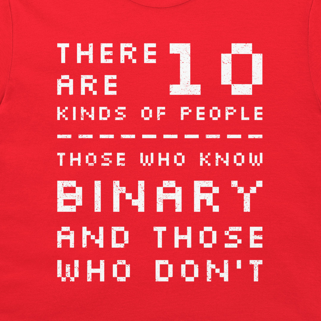A close-up of a red t-shirt featuring a white pixelated graphic that reads 'THERE ARE 10 KINDS OF PEOPLE THOSE WHO KNOW BINARY AND THOSE WHO DON'T'.