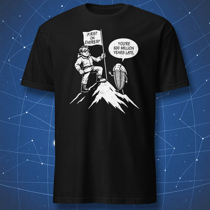 Cartoon mountaineer holding “First on Everest” flag while a trilobite says “You’re 500 million years late” on black shirt