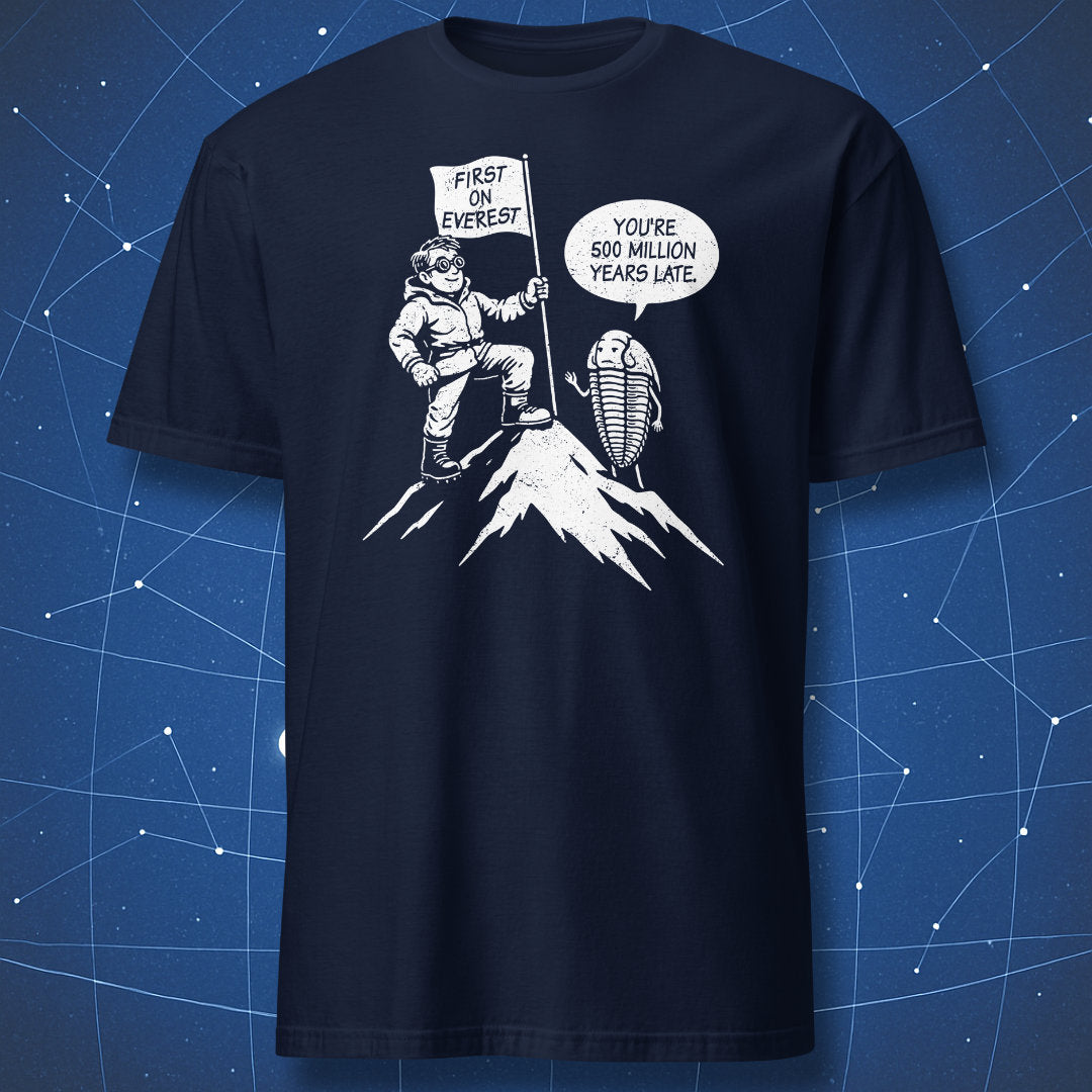 Cartoon Everest climber with flag and trilobite joke about being 500 million years late on navy blue shirt