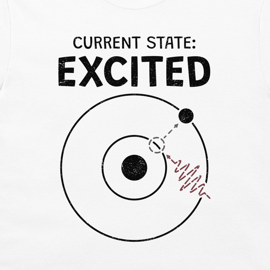 White t-shirt featuring a black graphic print with the text 'CURRENT STATE: EXCITED' above a circular atom model illustration with a red wavy line.