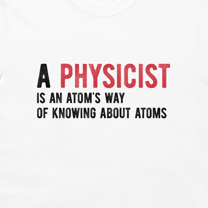 White t-shirt featuring a printed graphic that reads 'A PHYSICIST IS AN ATOM'S WAY OF KNOWING ABOUT ATOMS' in black and red text.