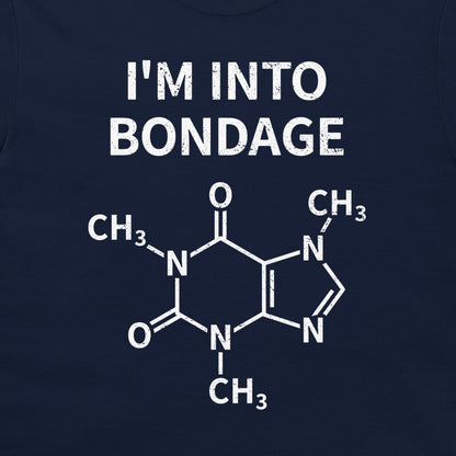 A close-up of a navy blue garment, likely a t-shirt, featuring a white graphic print. The print displays the text 'I'M INTO BONDAGE' above a chemical structure diagram of caffeine.