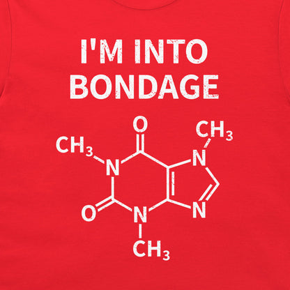 A close-up of a bright red garment, likely a t-shirt, featuring a white graphic print. The print displays the text 'I'M INTO BONDAGE' above a chemical structure diagram of caffeine.