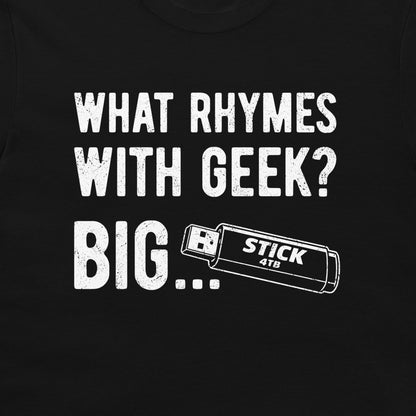 A close-up of a black t-shirt, featuring a white distressed graphic print that reads 'WHAT RHYMES WITH GEEK? BIG... and a USB stick graphic.