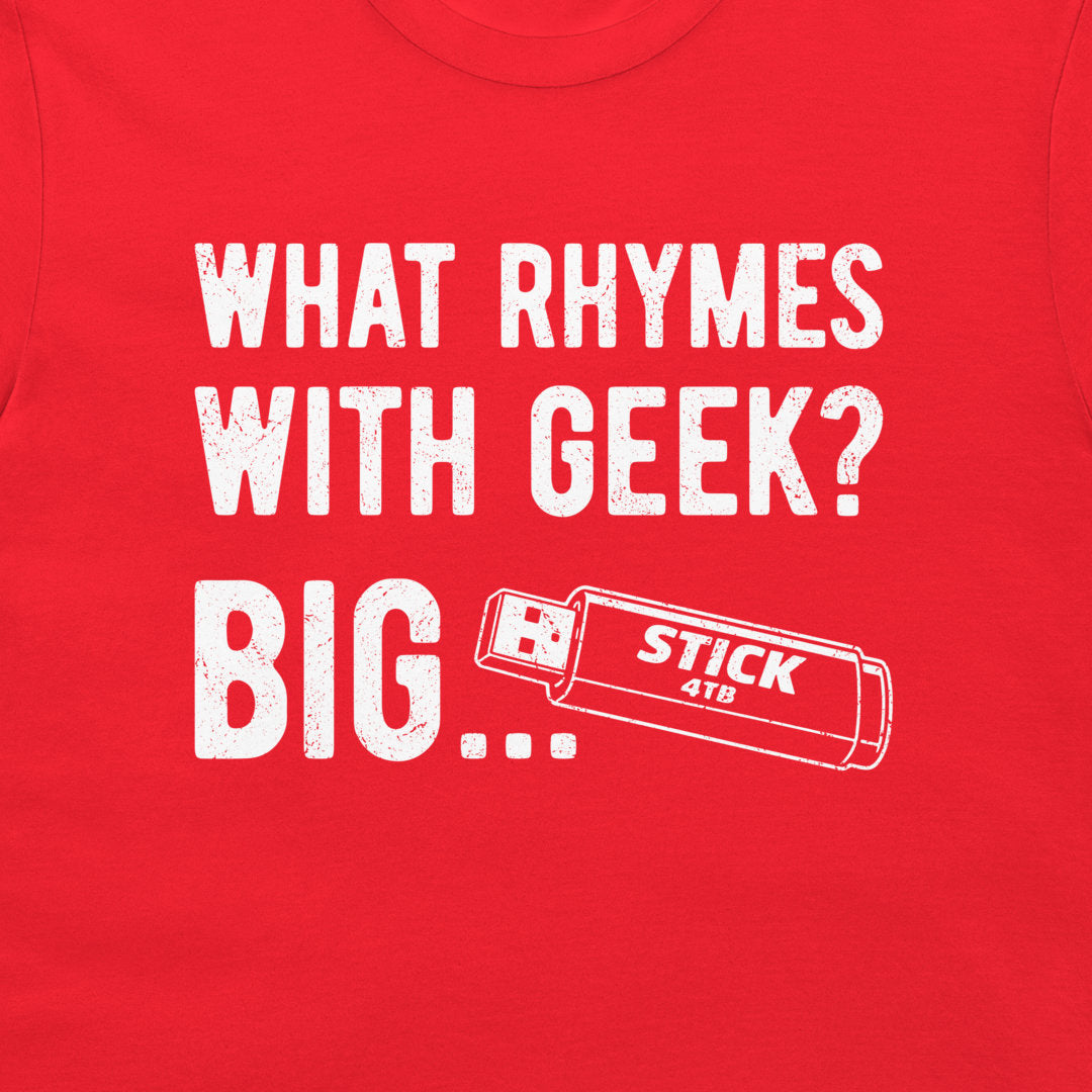 A close-up of a bright red t-shirt featuring a white distressed graphic that reads 'WHAT RHYMES WITH GEEK? BIG..' and a USB stick graphic.