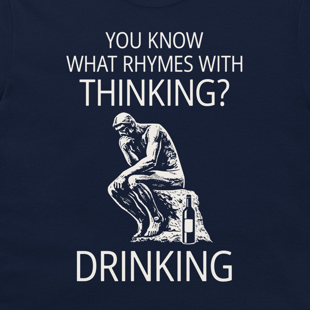 A dark navy blue t-shirt featuring a white graphic print of the Thinker statue from The Metamorphosis next to a wine bottle, with the text 'YOU KNOW WHAT RHYMES WITH THINKING? DRINKING'.