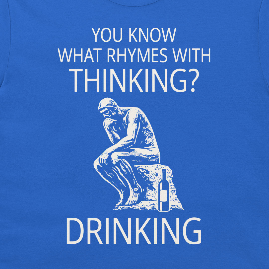 A close-up of a royal blue t-shirt featuring a white graphic print. The design references 'The Thinker' statue sitting on a rock next to a bottle, with the text 'YOU KNOW WHAT RHYMES WITH THINKING? DRINKING' in white capital letters.