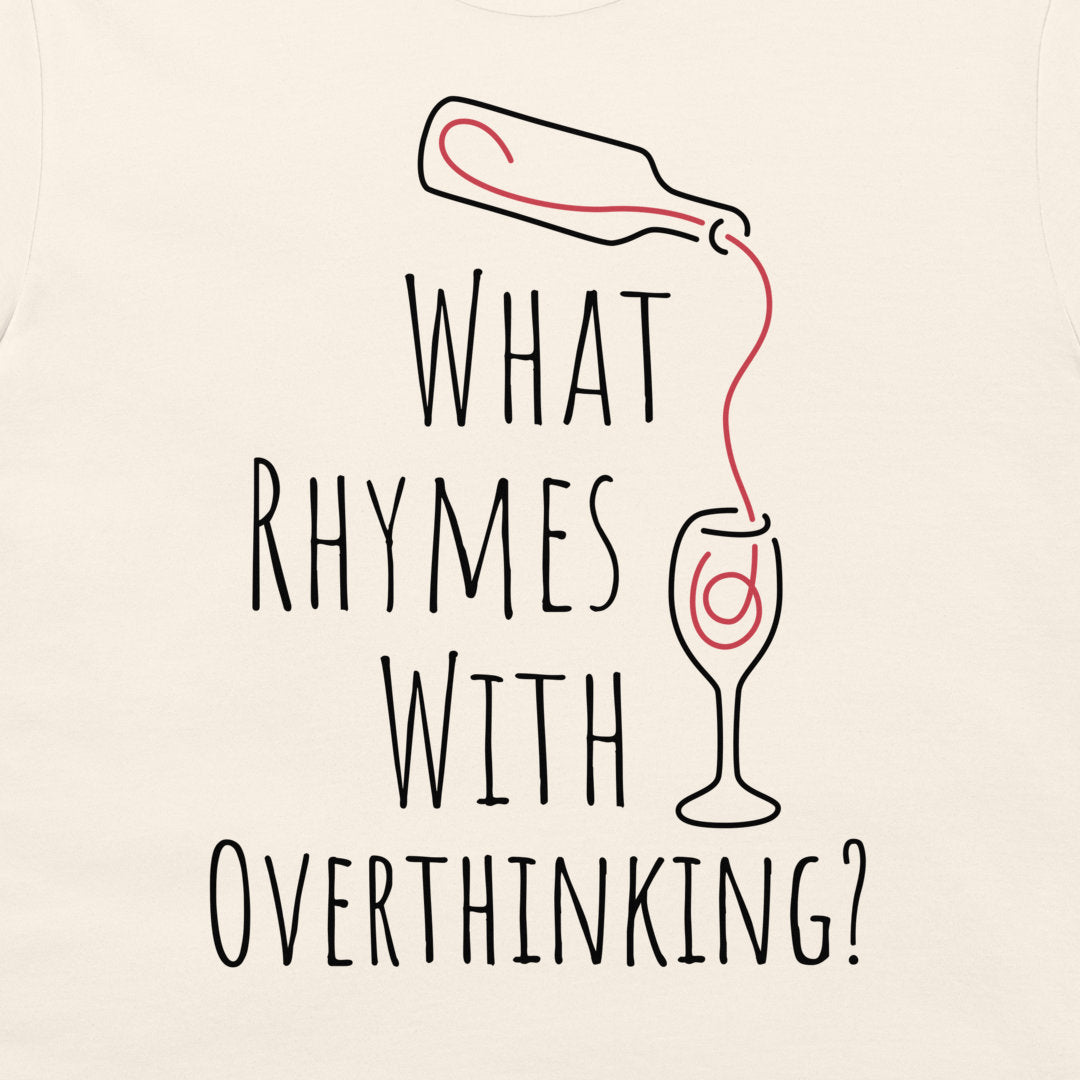 An off-white t-shirt featuring a humorous graphic print with the text 'WHAT RHYMES WITH OVERTHINKING?' in a black hand-drawn font. Above the text, a simple black line drawing shows a bottle pouring a red liquid into a wine glass, which has a red swirl inside.