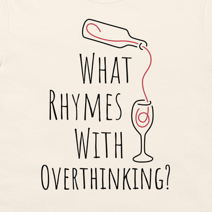 An off-white t-shirt featuring a humorous graphic print with the text 'WHAT RHYMES WITH OVERTHINKING?' in a black hand-drawn font. Above the text, a simple black line drawing shows a bottle pouring a red liquid into a wine glass, which has a red swirl inside.