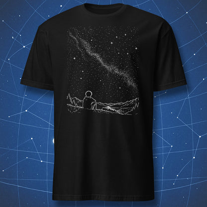 Black t-shirt with a graphic of a person sitting on a mountain looking at the stars, against a starry night sky background.