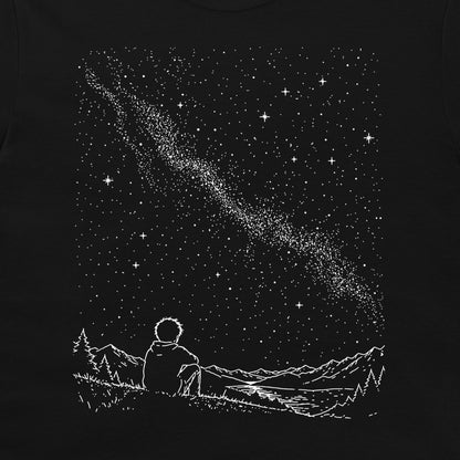 A black graphic print featuring a white line-art illustration of a person sitting in a field of mountains and stars, gazing up at a starry night sky with a shooting star.