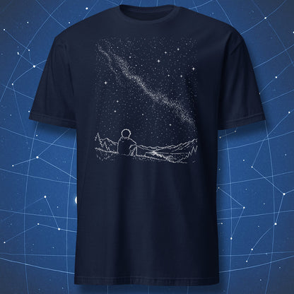 Navy blue t-shirt with a graphic of a person sitting on a mountain under a starry sky, against a starry night sky background.
