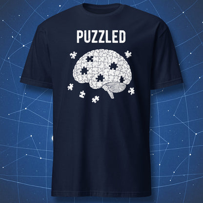 white brain puzzle graphic with missing pieces and “Puzzled” text on navy blue shirt