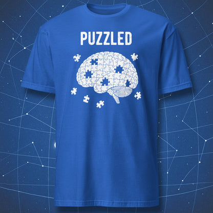 white puzzle brain illustration with loose pieces and “Puzzled” typography on royal blue shirt