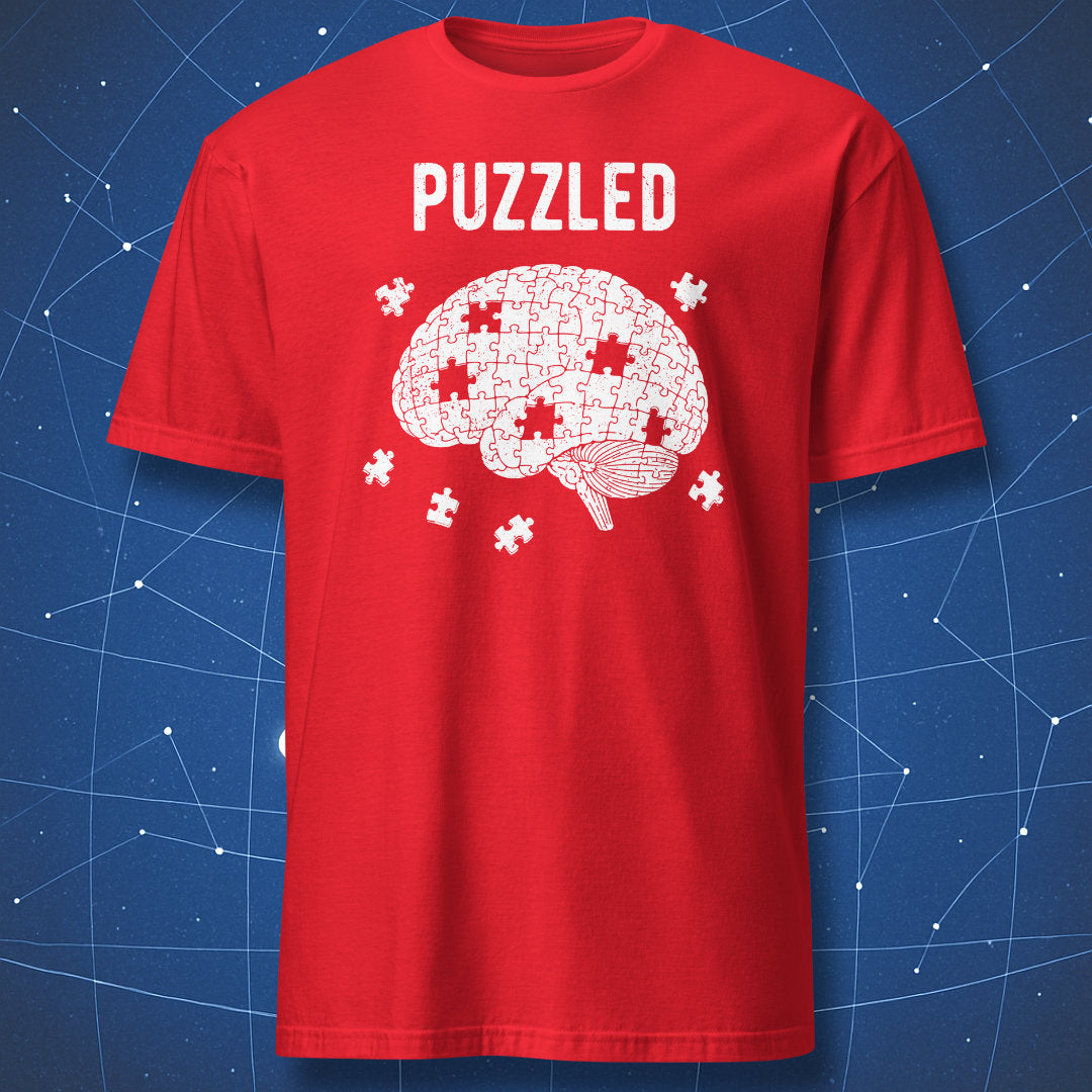 white brain made of puzzle pieces with gaps and “Puzzled” text on red shirt