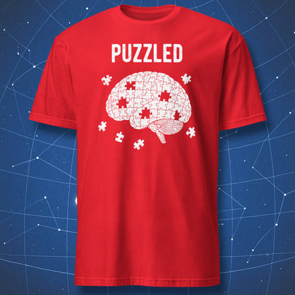 white brain made of puzzle pieces with gaps and “Puzzled” text on red shirt