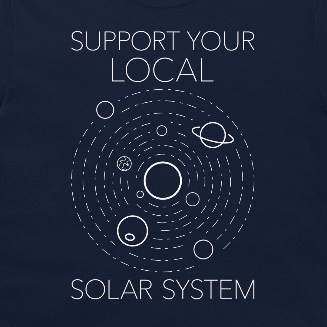 A close-up of a navy blue t-shirt featuring a white graphic of the solar system with the text 'SUPPORT YOUR LOCAL SOLAR SYSTEM'.