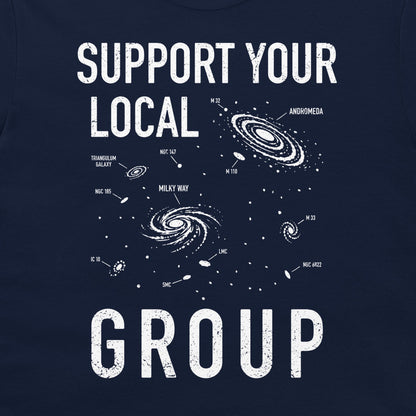 A navy blue graphic print on a t-shirt featuring white distressed text that reads 'SUPPORT YOUR LOCAL GROUP' with white space illustrations of galaxies and stars.