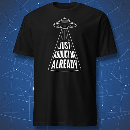 Black t-shirt with minimalist UFO beam design and “Just Abduct Me Already” text