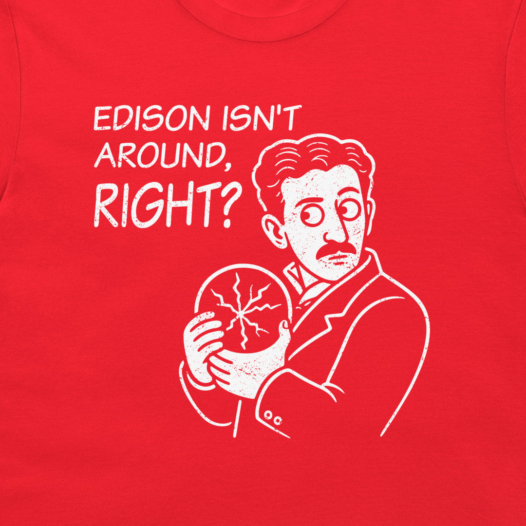 A close-up of a bright red t-shirt featuring a white graphic print of a Nikola Tesla, with the text 'EDISON ISN'T AROUND, RIGHT?' printed above him.