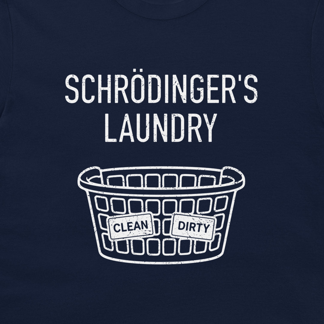A close-up of a navy blue t-shirt, featuring a white graphic print that reads 'SCHRÖDINGER'S LAUNDRY' above a laundry basket with 'CLEAN' and 'DIRTY' labels.