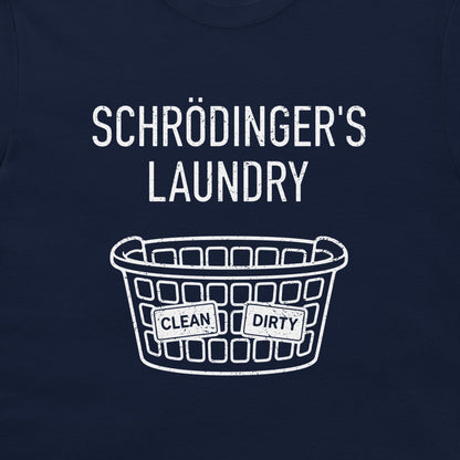A close-up of a navy blue t-shirt, featuring a white graphic print that reads 'SCHRÖDINGER'S LAUNDRY' above a laundry basket with 'CLEAN' and 'DIRTY' labels.