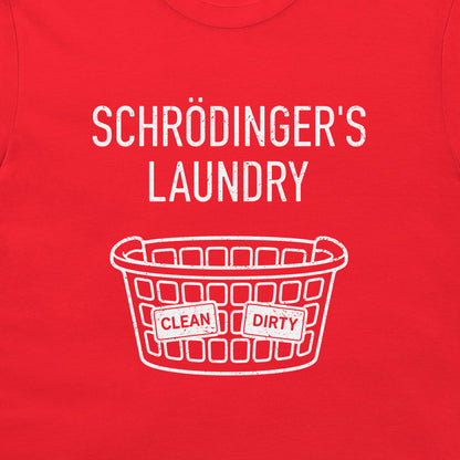 A close-up of a bright red t-shirt, featuring a white graphic print that reads 'SCHRÖDINGER'S LAUNDRY' above a white laundry basket illustration with 'CLEAN' and 'DIRTY' labels.