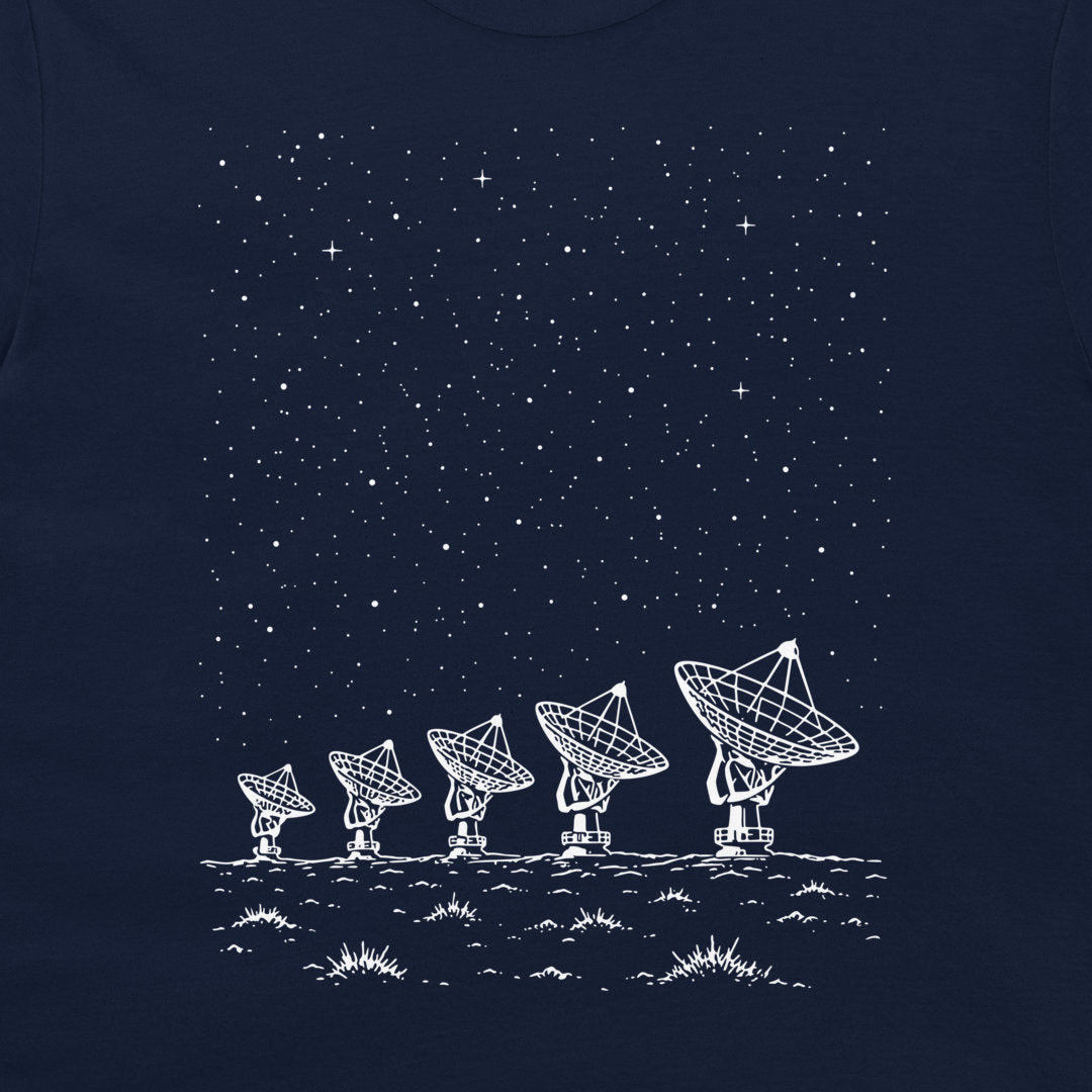 A dark navy blue t-shirt featuring a white graphic print of five radio telescope antennas on a desert-like ground under a starry night sky.