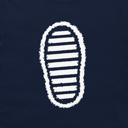 A close-up of a navy blue t-shirt, featuring a white graphic print of a shoe sole with horizontal stripes.