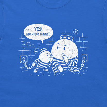 A close-up of a blue T-shirt featuring a white distressed graphic of two cartoon prisoner particles in striped jumpsuits, one with a head through a lock and the other saying 'YES, QUANTUM TUNNEL' in a speech bubble.