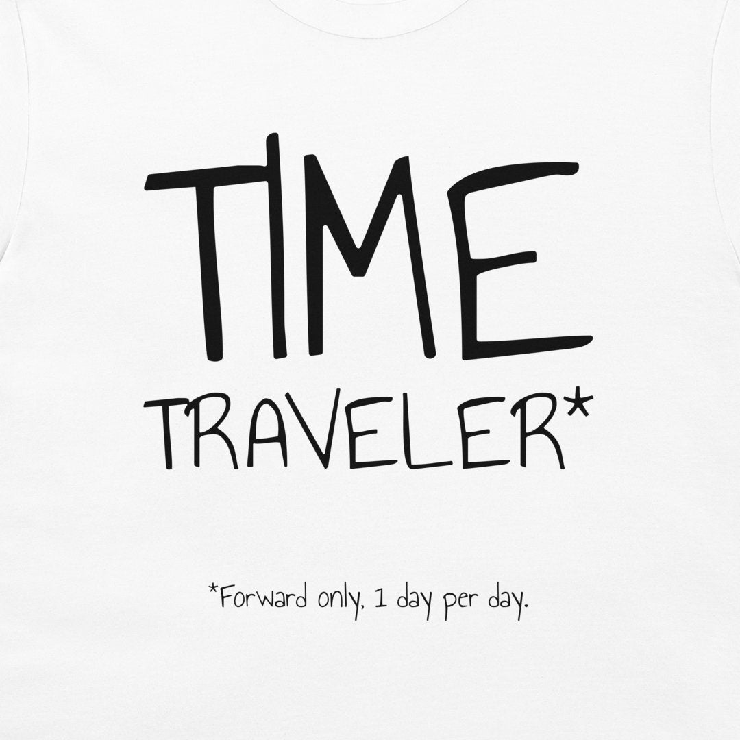 White t-shirt featuring a black graphic print that reads 'TIME TRAVELER*' with the note '*Forward only, 1 day per day.' printed below.