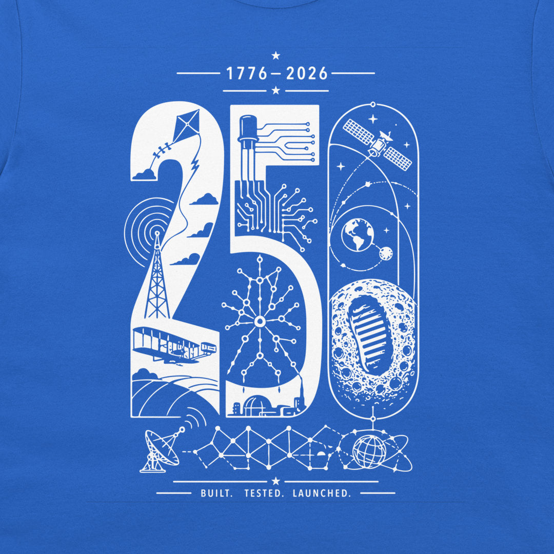 A close-up of a royal blue t-shirt, featuring a white graphic print celebrating the year 2026 with space and technology motifs.