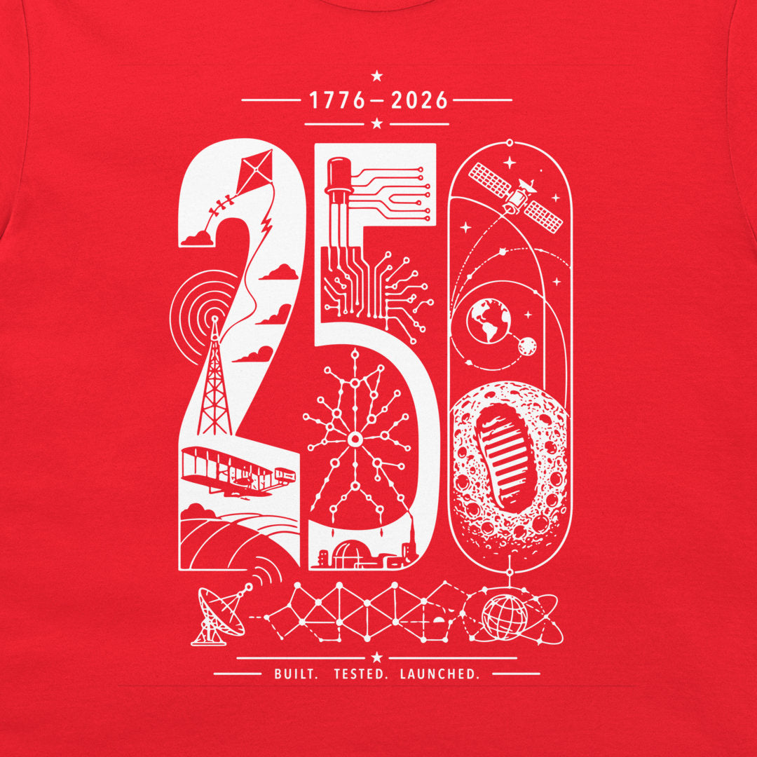 A close-up of a red t-shirt, featuring a white graphic print of the numbers '20' and '50' filled with various technology and space-themed illustrations, including a satellite, globe, moon, and rocket. The text '1776-2026' and 'BUILT. TESTED. LAUNCHED.'.