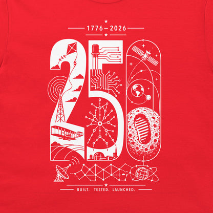A close-up of a red t-shirt, featuring a white graphic print of the numbers '20' and '50' filled with various technology and space-themed illustrations, including a satellite, globe, moon, and rocket. The text '1776-2026' and 'BUILT. TESTED. LAUNCHED.'.
