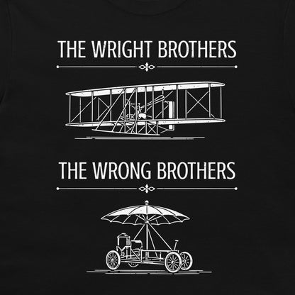 A black t-shirt featuring a white graphic print with the text 'THE WRIGHT BROTHERS' above a line drawing of a vintage biplane, and 'THE WRONG BROTHERS' below a line drawing of an early automobile with an umbrella.