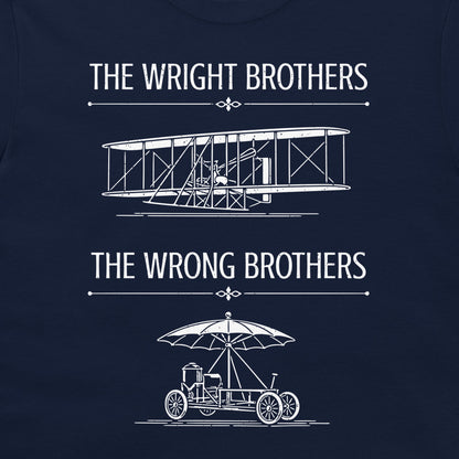 A navy blue t-shirt featuring a white graphic print with the text 'THE WRIGHT BROTHERS' above a line drawing of a vintage biplane, and 'THE WRONG BROTHERS' below a line drawing of an early automobile with an umbrella.